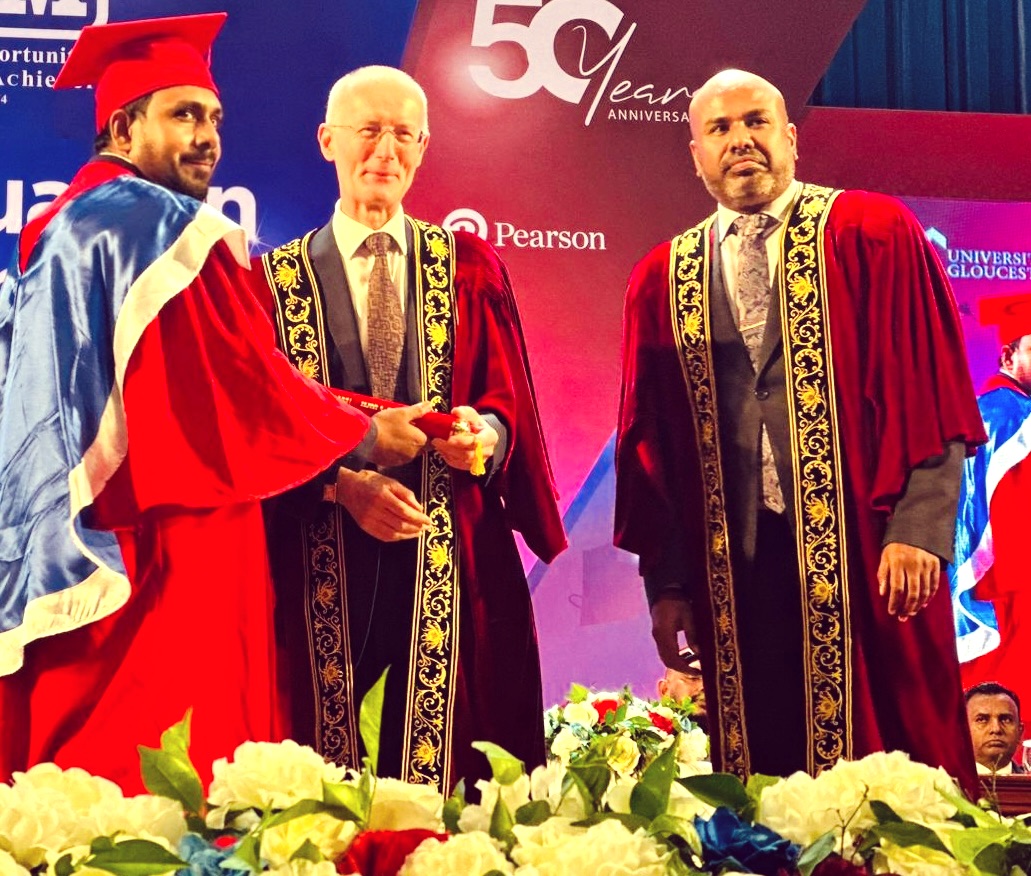 Sanjeewa in academic robes with two colleagues at a graduation ceremony